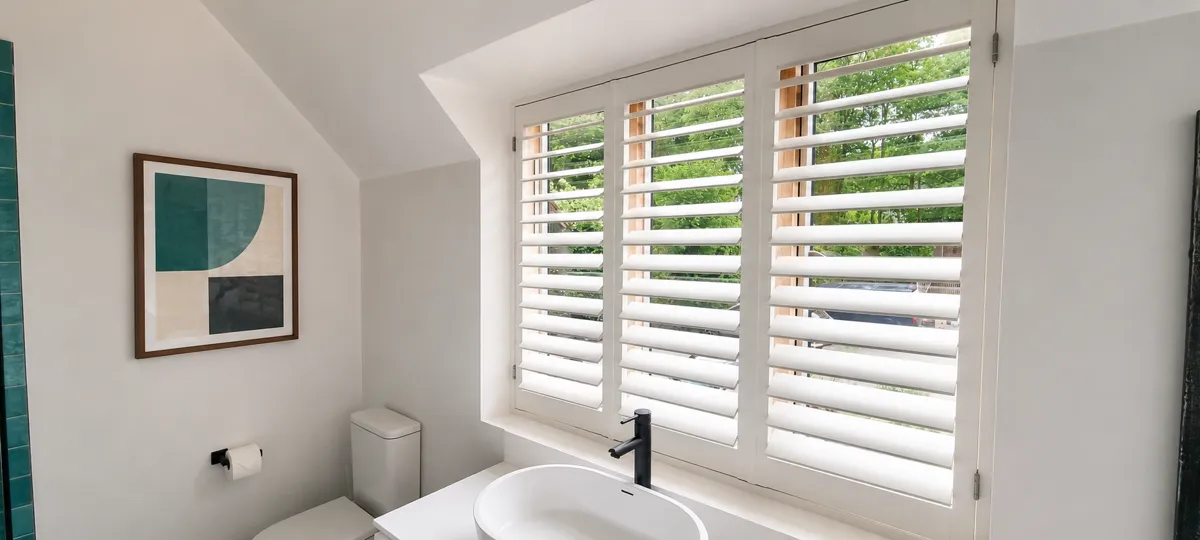 White shutters above a bathroom basin